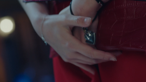 Zhu Hong's bell charm Zhu Hong clutches at her bracelet's bell charm